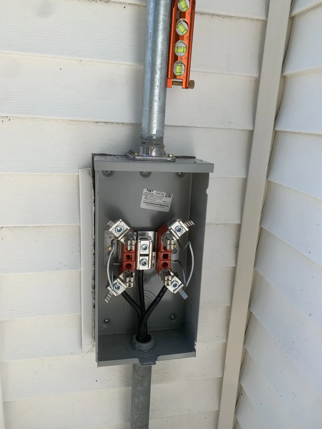 Exterior electrical meter and service disconnect wired by Tritan