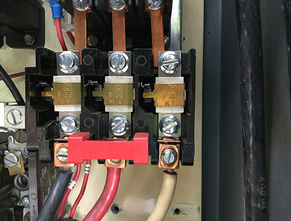 Closeup of electrical relay contactors in a customer service panel