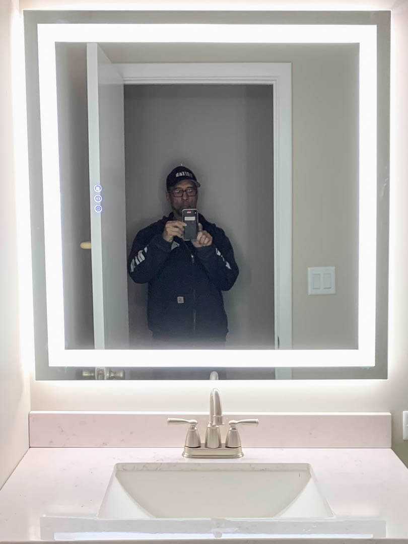 LED-lit bathroom mirror installed by Tritan Services electricians in a customer home