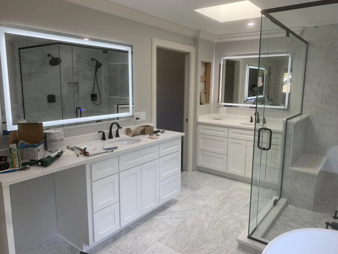 Bathroom remodel with a glass shower and double vanity by Tritan